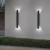 Matte black waterproof wall light in garden setting